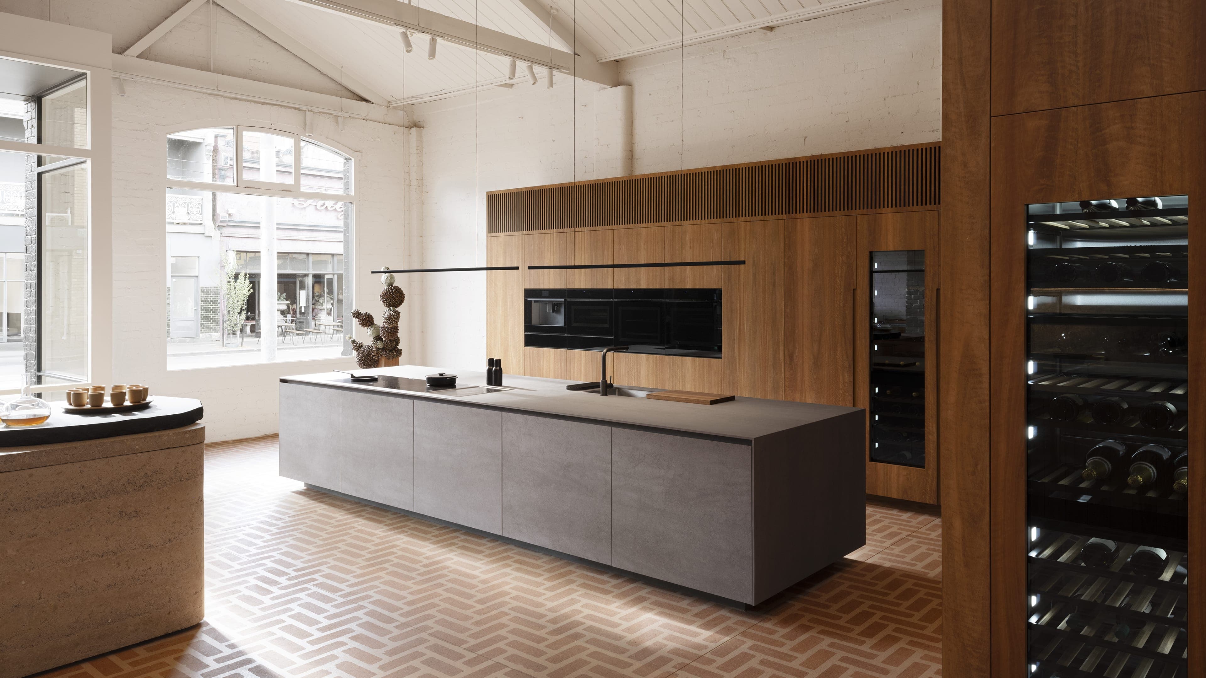 Fisher & Paykel im Melbourne Experience Centre: minimalistische Premium-Architektur-Küche mit Steam-Oven und Weinkühlschrank in Holz-Furnier-Front